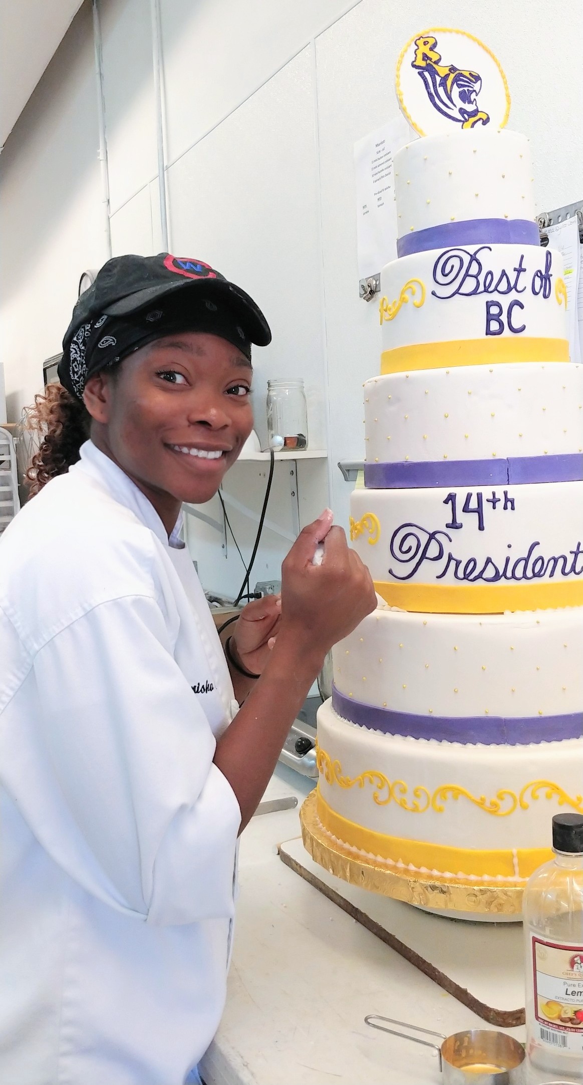Volleyball alumna decorates a cake at her bakery
