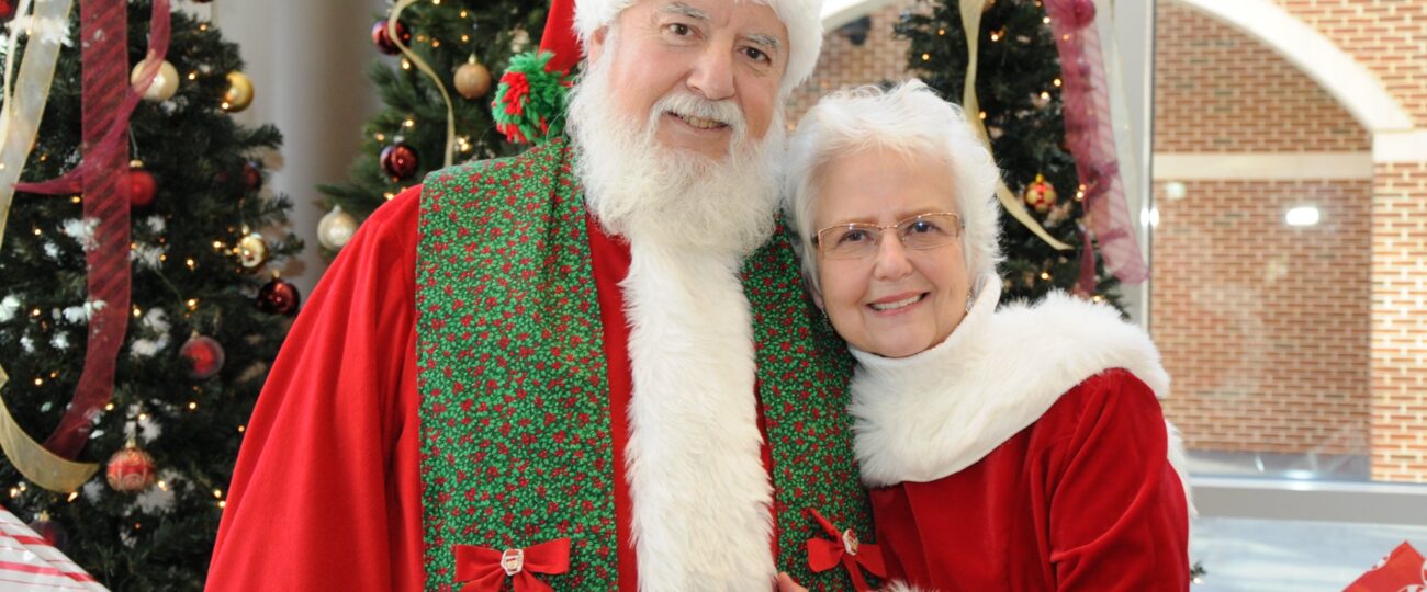 Mr. and Mrs. Davis dressed as Mr. and Mrs. Clause in Digs.